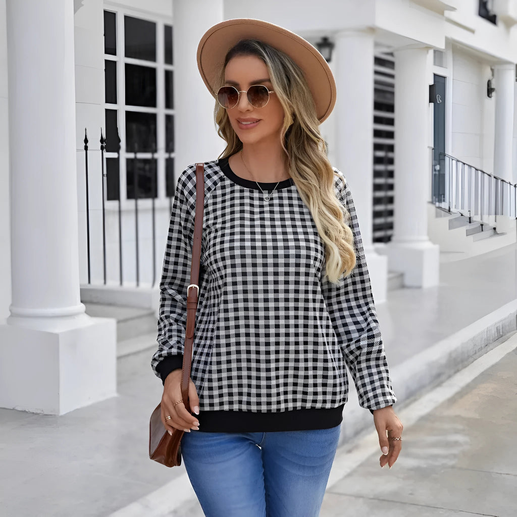Black long sleeve pullover sweater with plaid pattern and printing detail showing front view