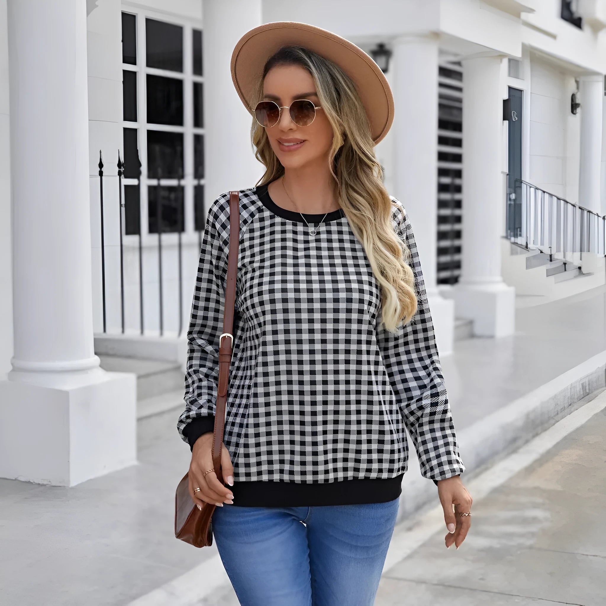 Black long sleeve pullover sweater with plaid pattern and printing detail showing front view