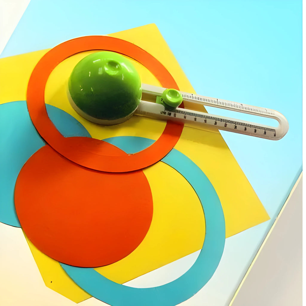 Plastic round paper cutter in orange colour on green background with A3 cutting capacity