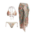 Creamy-white floral women's bikini set with matching skirt on beach