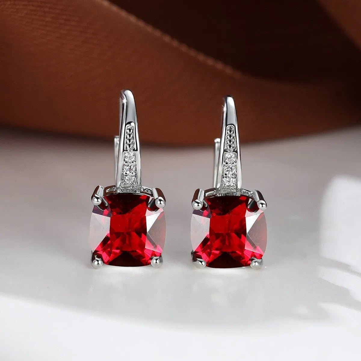 Square geometric ear hook studs with a round zircon stone, shown in a gold electroplated finish.