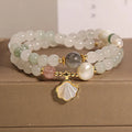 Women's artistic crystal bracelet with a green Tianshan Jade ginkgo leaf pendant and gold-plated accents.