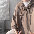 A man wearing a loose-fit black hooded short sleeve t-shirt made of polyester for summer.