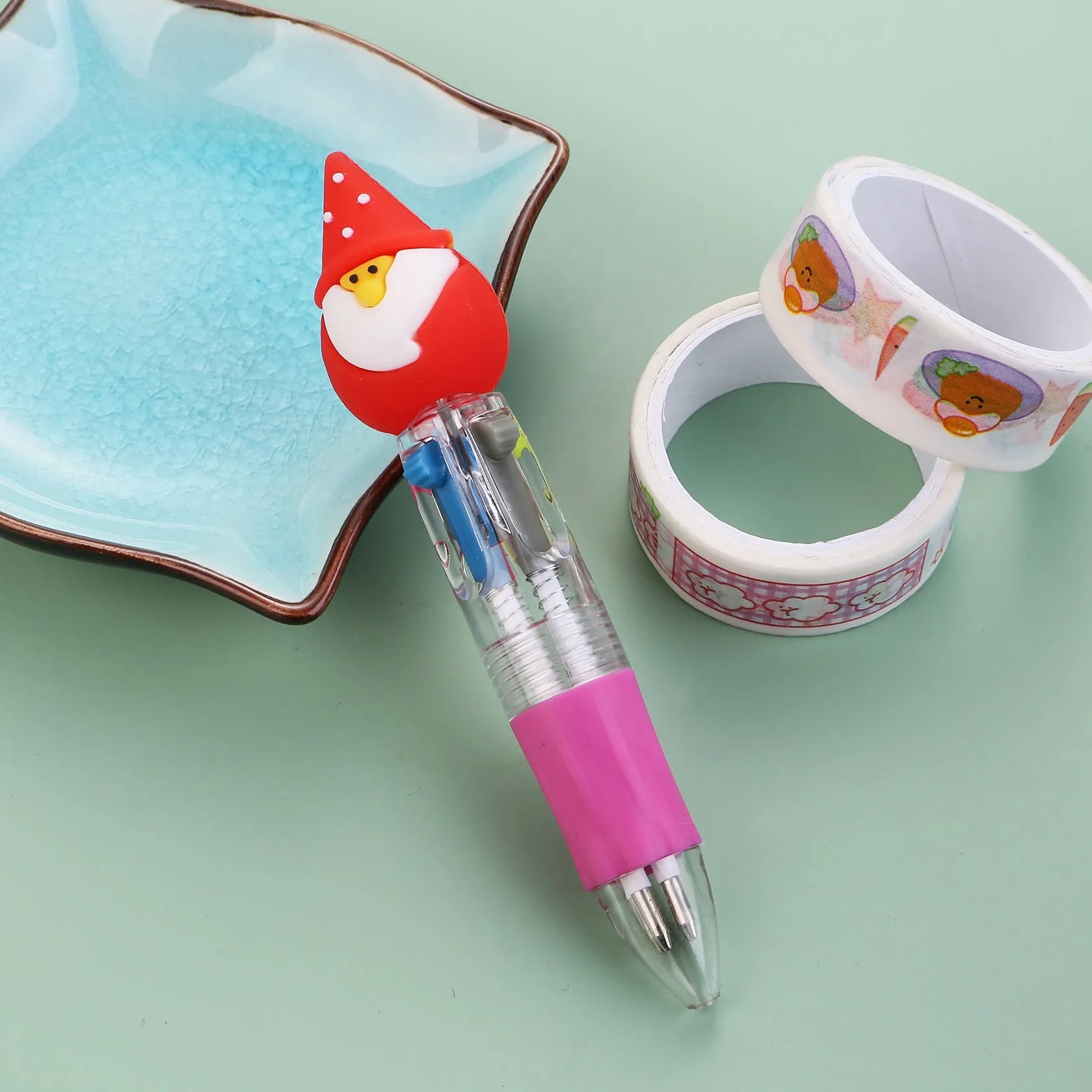 Compact 11cm Christmas-themed press-action ballpoint pen with festive designs.