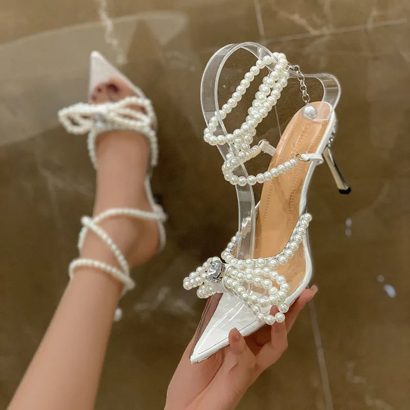 Silver women's ankle-strap buckle sandals with toe cap pearl and open toe on white background
