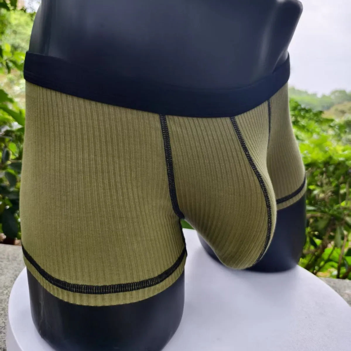 Solid colour men's boxers in breathable thin fabric offering hip lifting and body shaping support.