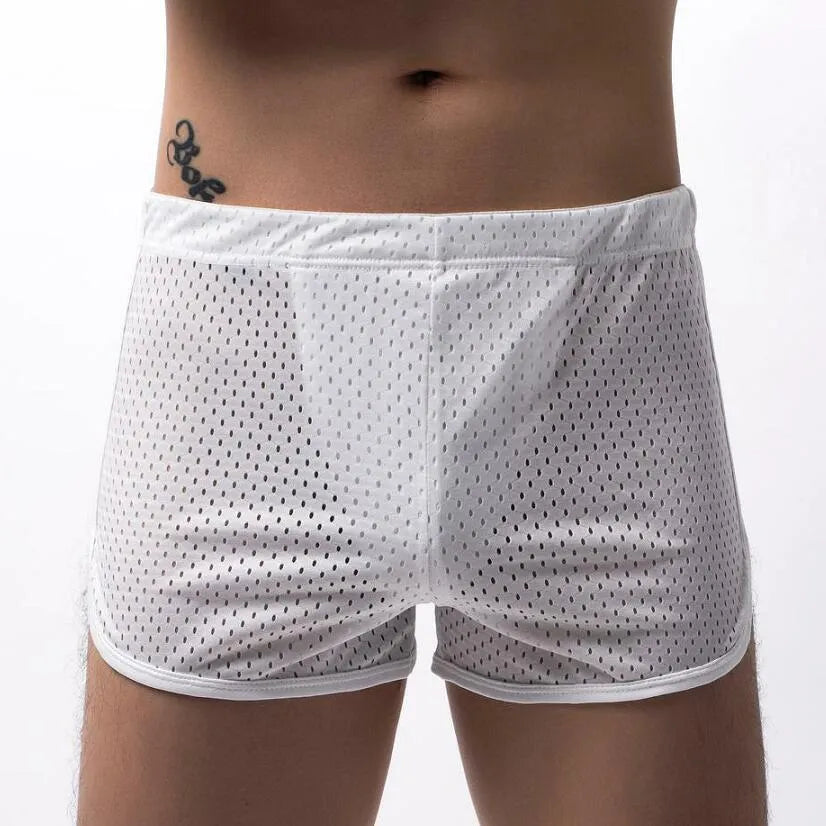 Men's solid colour boxer shorts in a cotton and nylon fabric blend, shown in black, on a mid-waist fit model.
