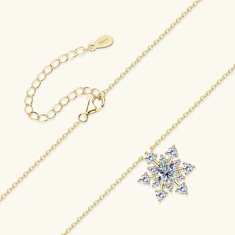 Gold snowflake moissanite pendant on silver 925 O-ring chain against white background