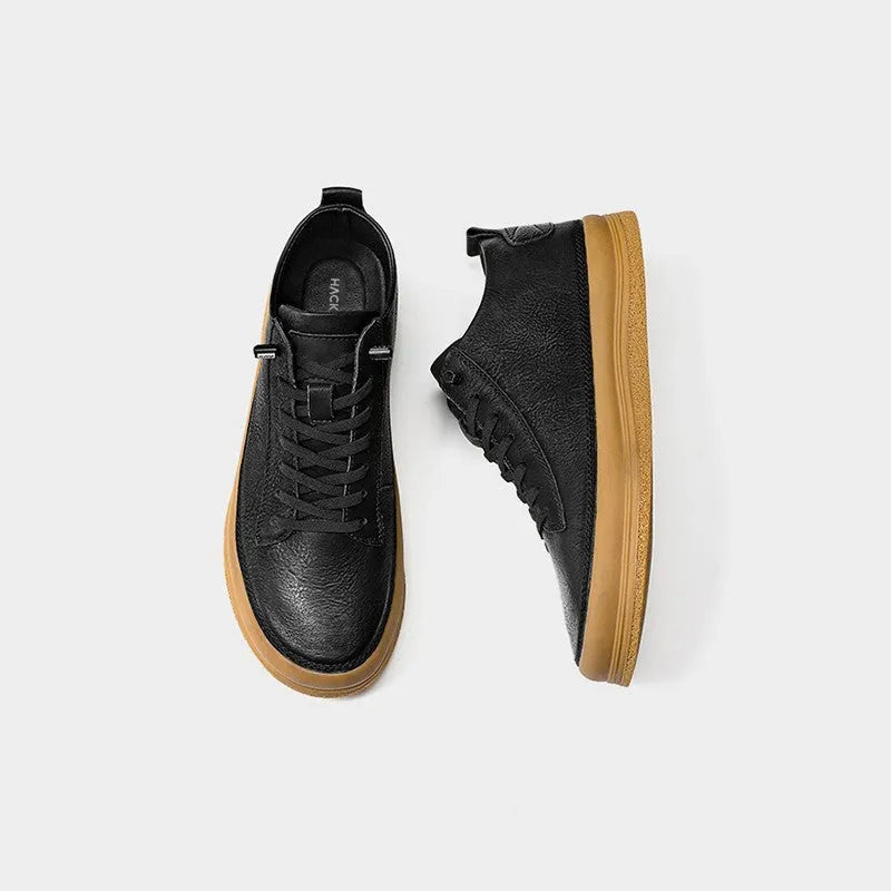 Men's black leather casual shoes with round toe and flat rubber sole on a white background.