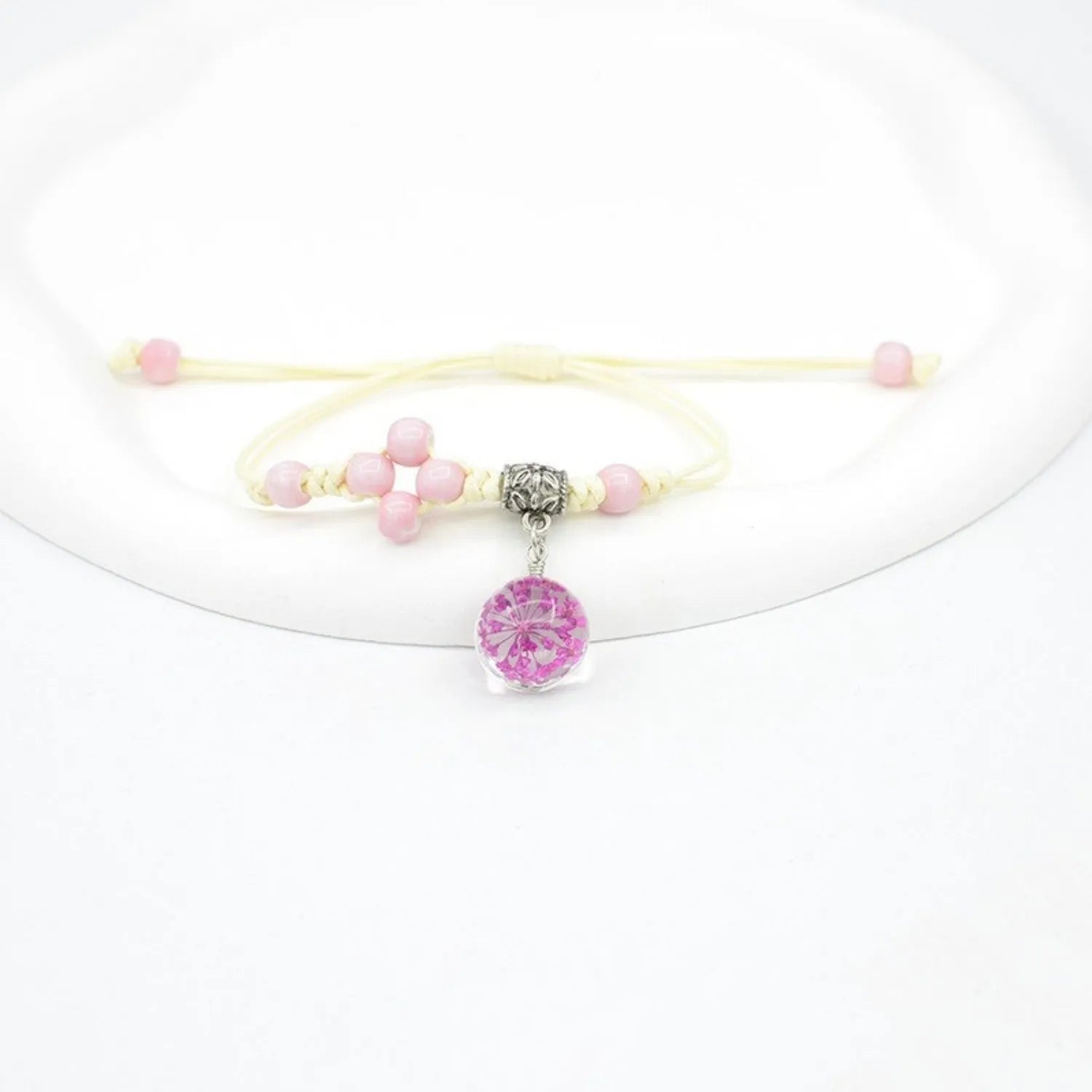 Hand-woven glass bracelet with 1.4cm beads containing real dried flowers in various colours