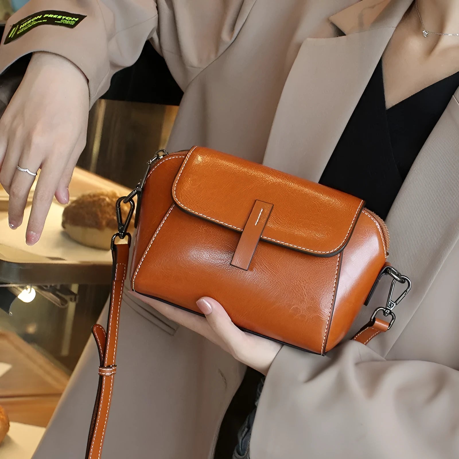 Women's brown oil wax leather messenger bag with cross-body strap and multiple internal compartments