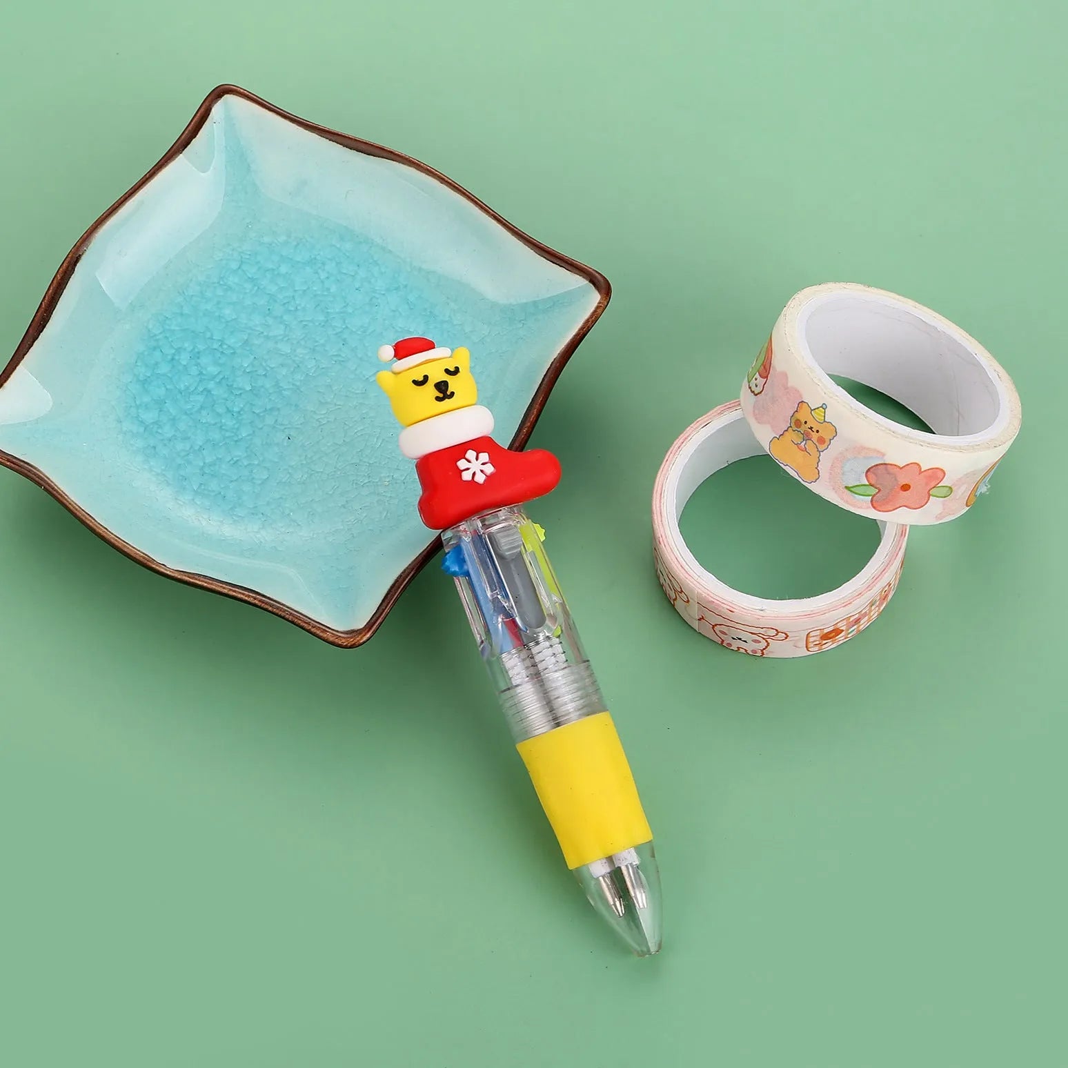 Compact 11cm Christmas-themed press-action ballpoint pen with festive designs.