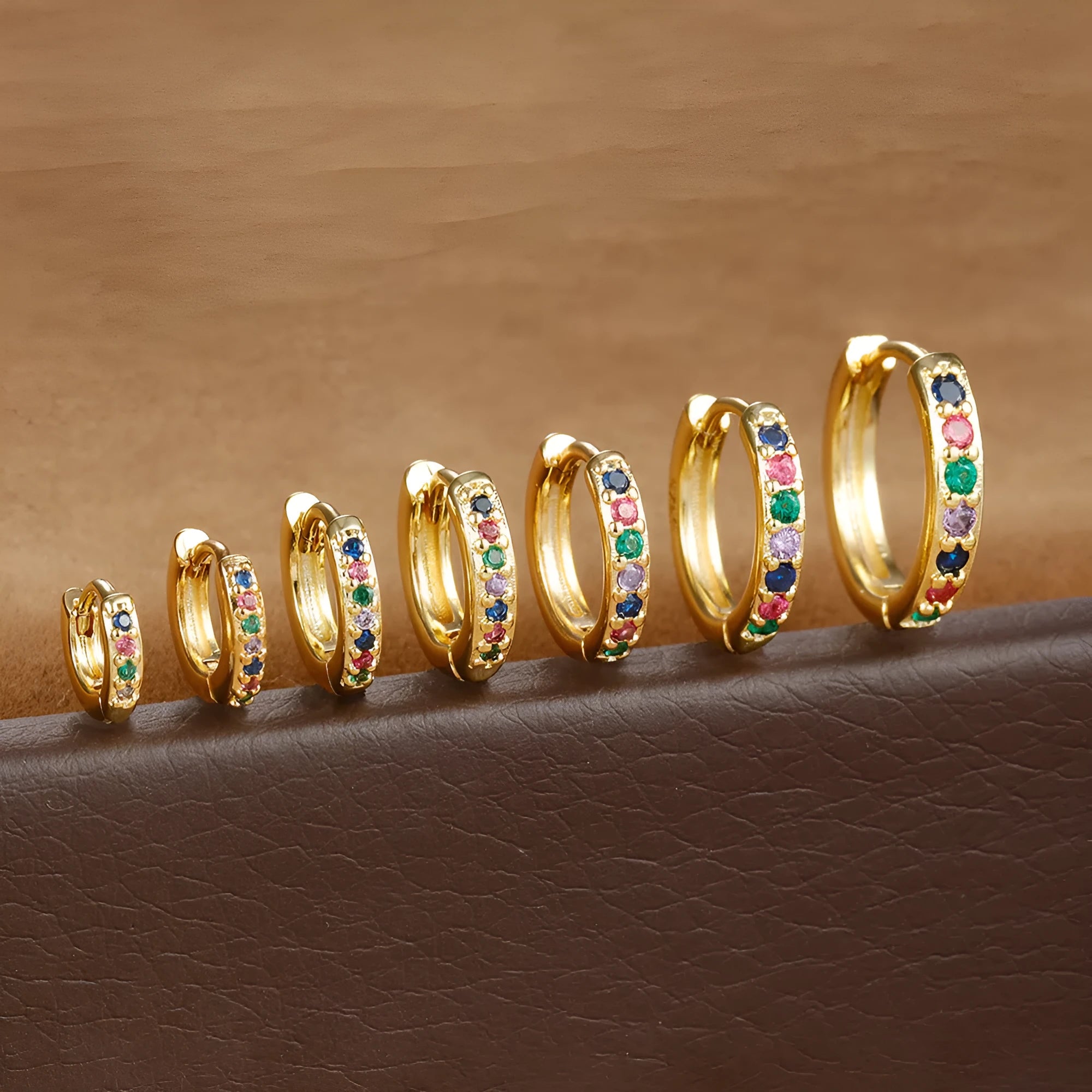 Geometric circle zircon perforated stud earrings in gold, rose gold, and silver colours showing perforated pattern detail