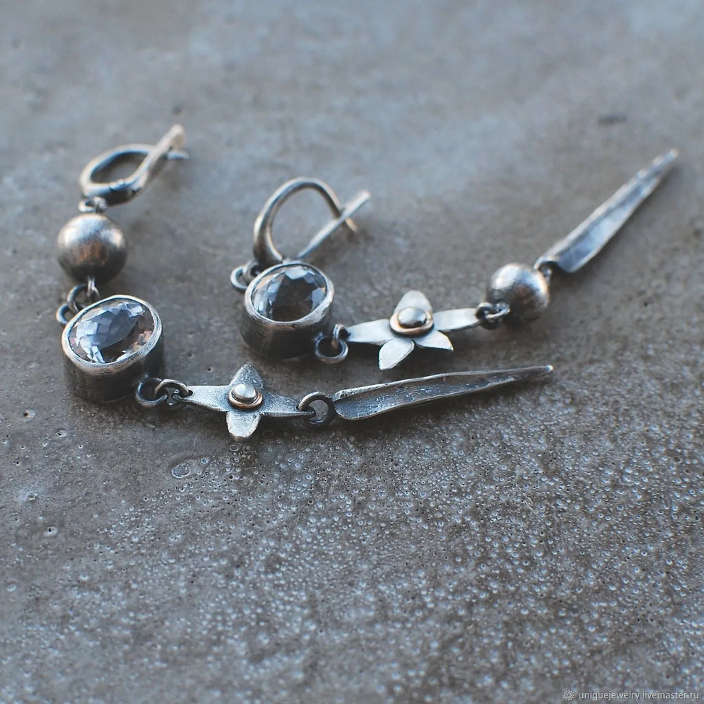 A pair of long geometric XINGX pendant earrings in antique silver with rhinestones.