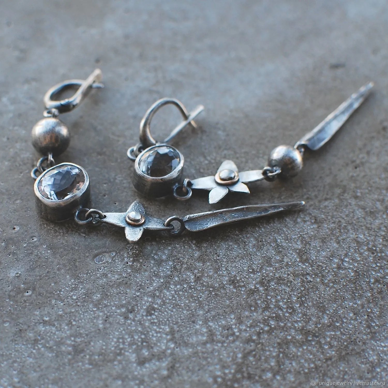 A pair of long geometric XINGX pendant earrings in antique silver with rhinestones.