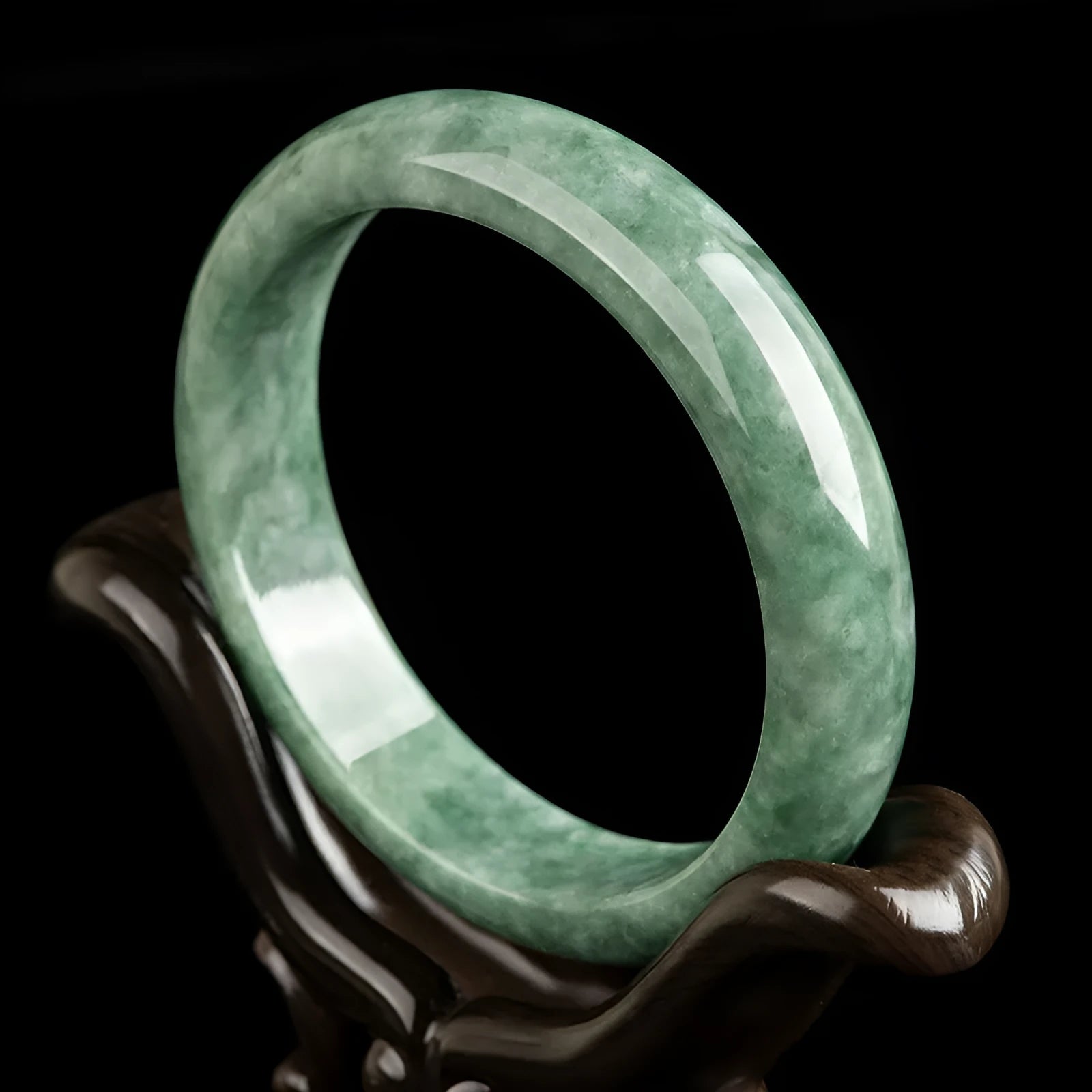 A simple deep pea green women's bracelet shown with a gift box and certificate.