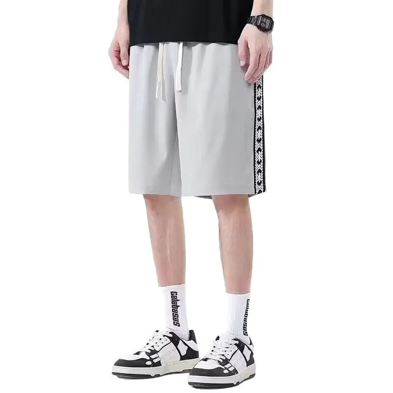 Men's loose black track pants with elastic waistband and baggy leg fit