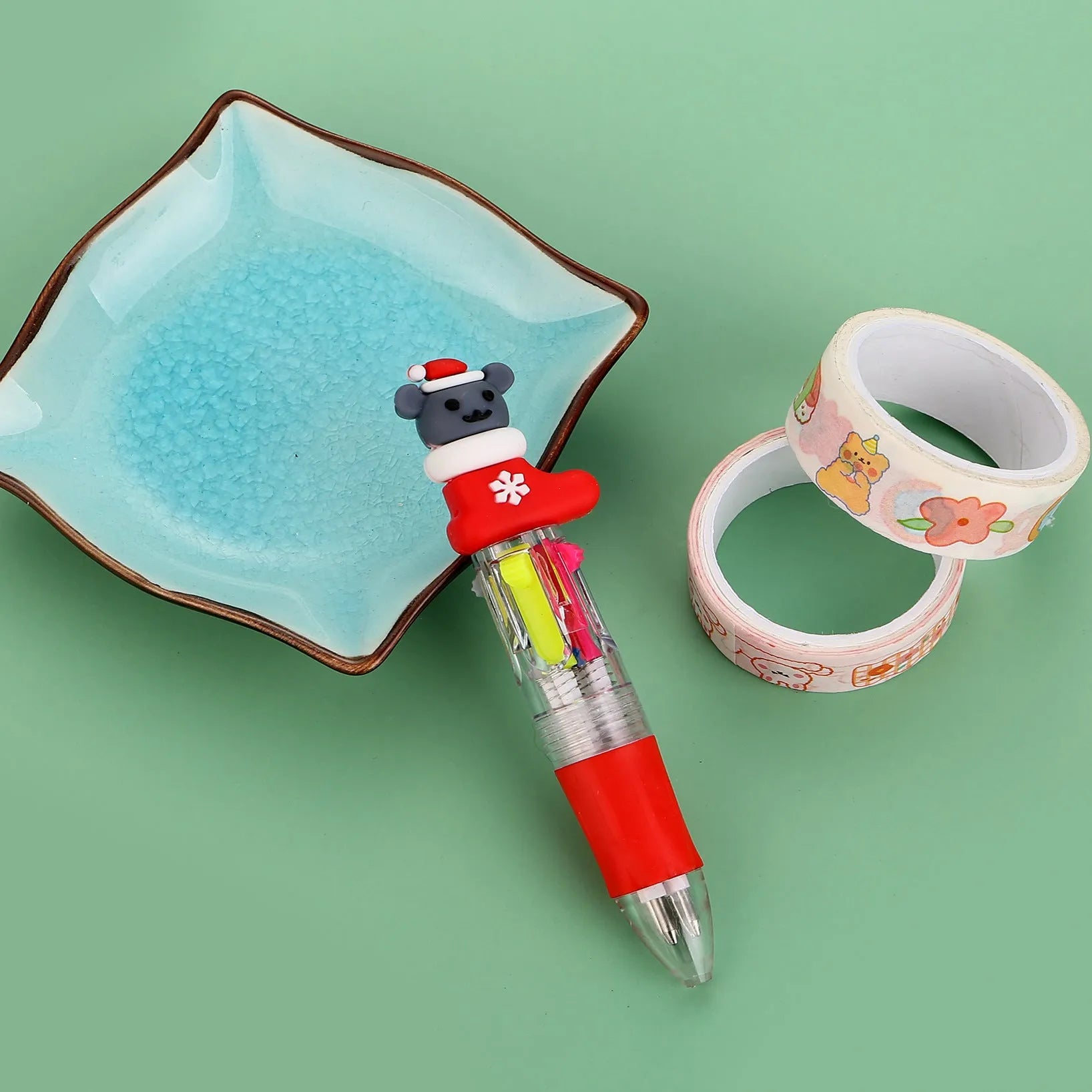 Compact 11cm Christmas-themed press-action ballpoint pen with festive designs.