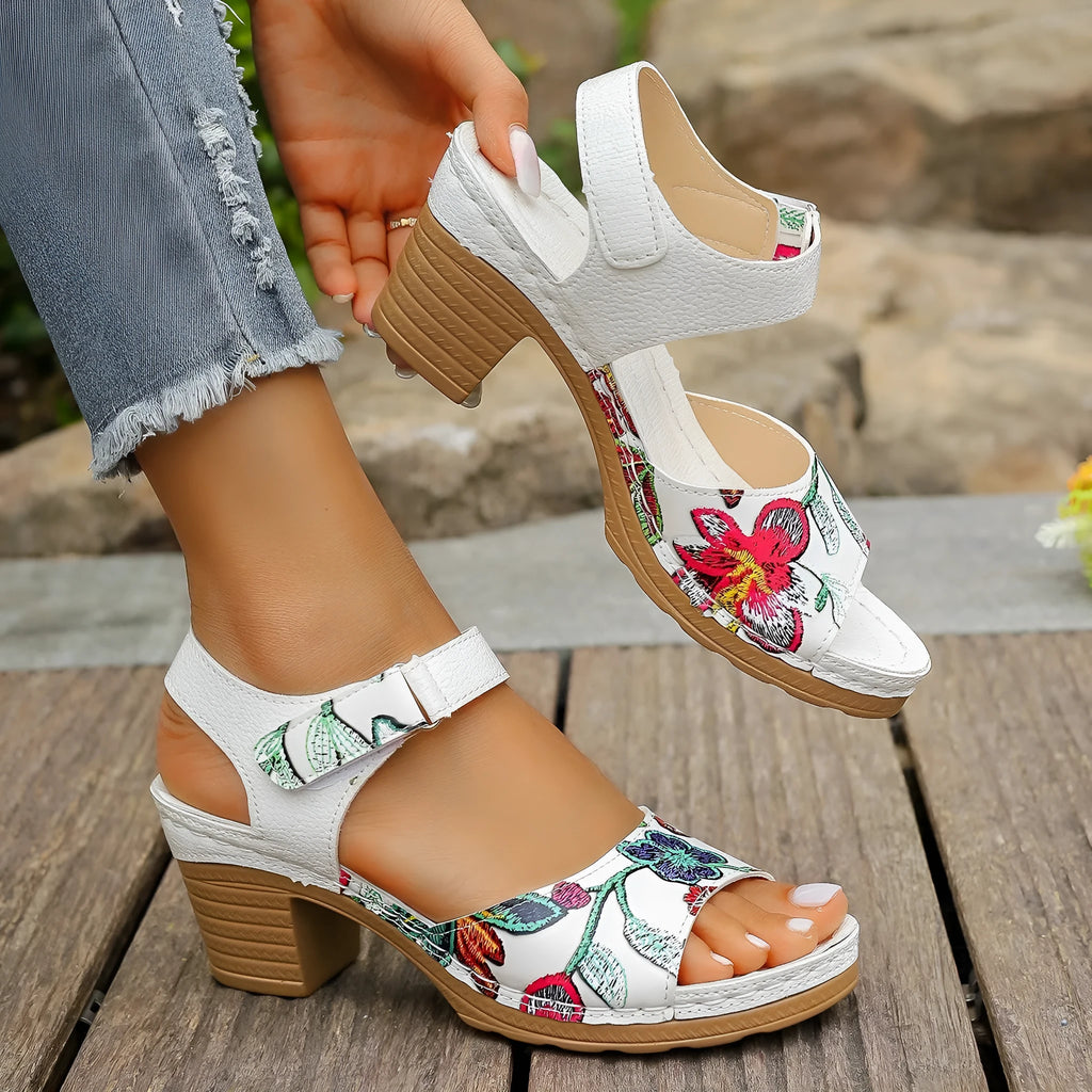 White women's high heel sandals with a visible Velcro strap buckle on a rubber sole.