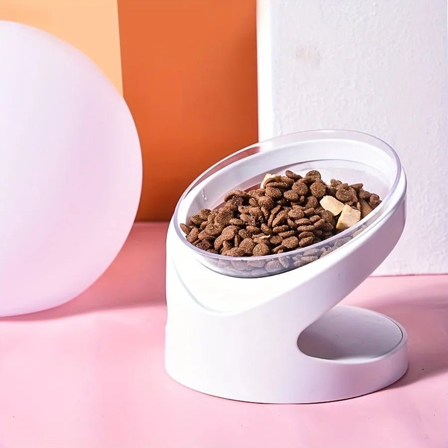 White clear plastic elevated cat food bowl with tilted anti-vomit design on a raised stand.