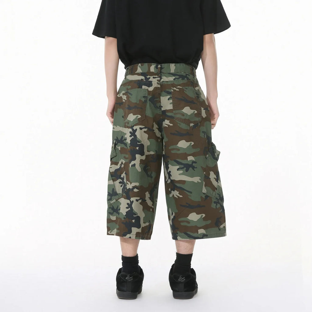 Men's camouflage coloured wide-leg cotton cargo trousers with large patch pockets and side stitching.