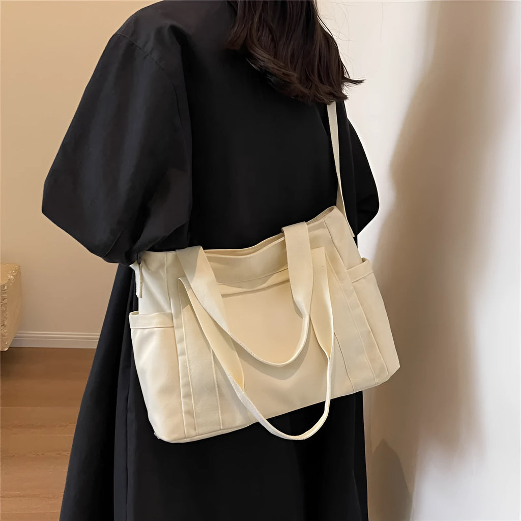 Polyester shoulder bag in solid colour with sandwich pocket and phone compartment