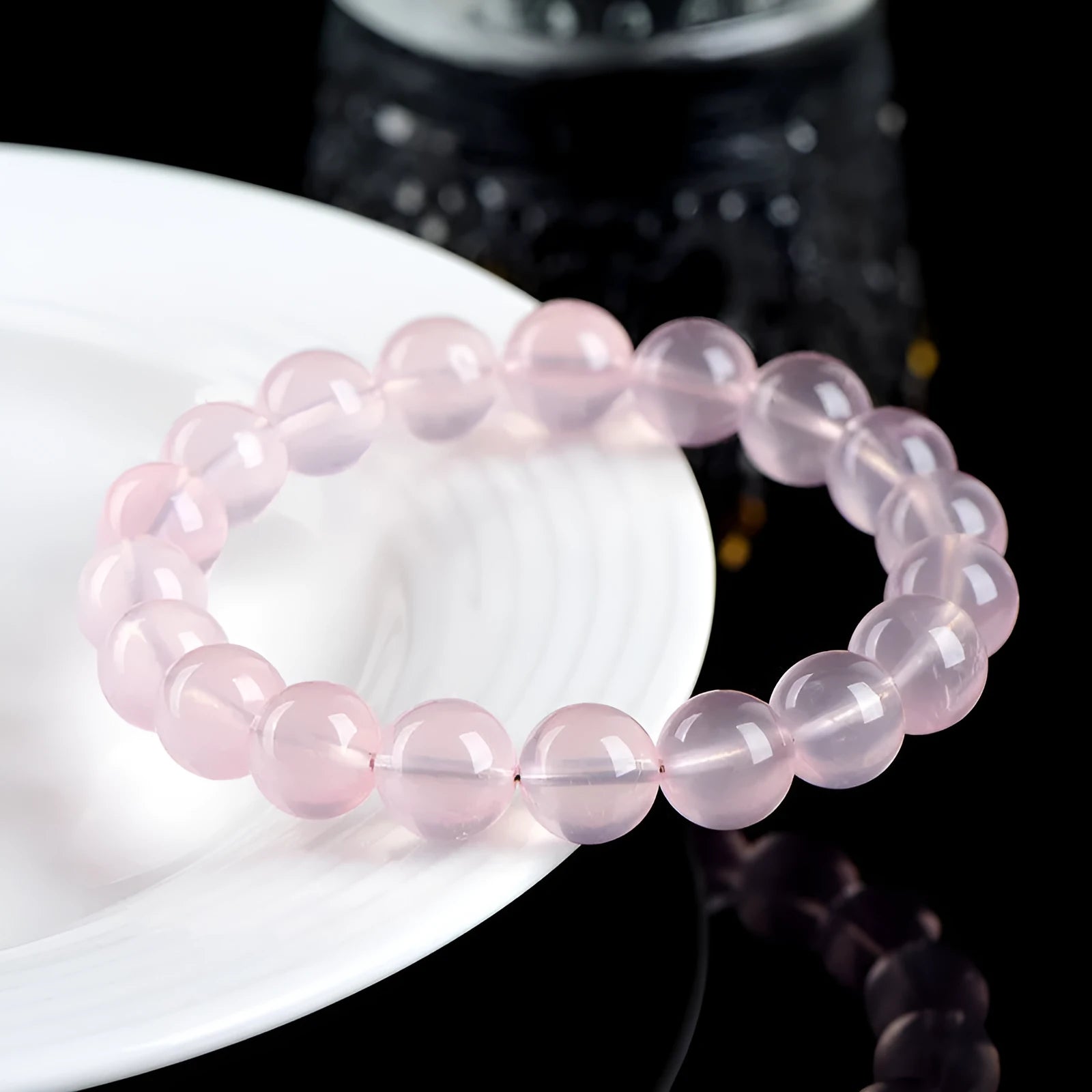 Pink crystal bracelet with round polished beads in natural starlight style showing size options from 6mm to 22mm diameter