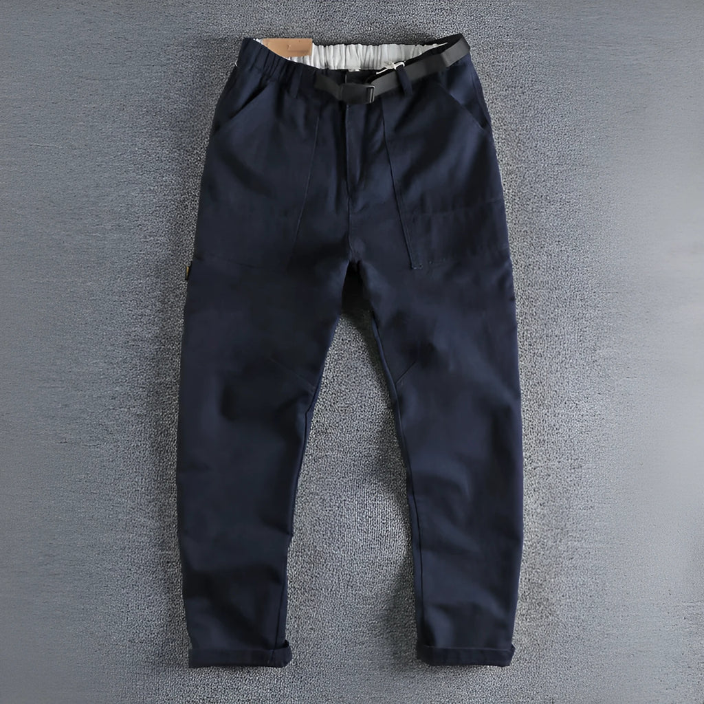 Men's khaki cotton work trousers showing N I buckle belt and three-dimensional cutting detail
