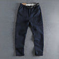 Men's khaki cotton work trousers showing N I buckle belt and three-dimensional cutting detail