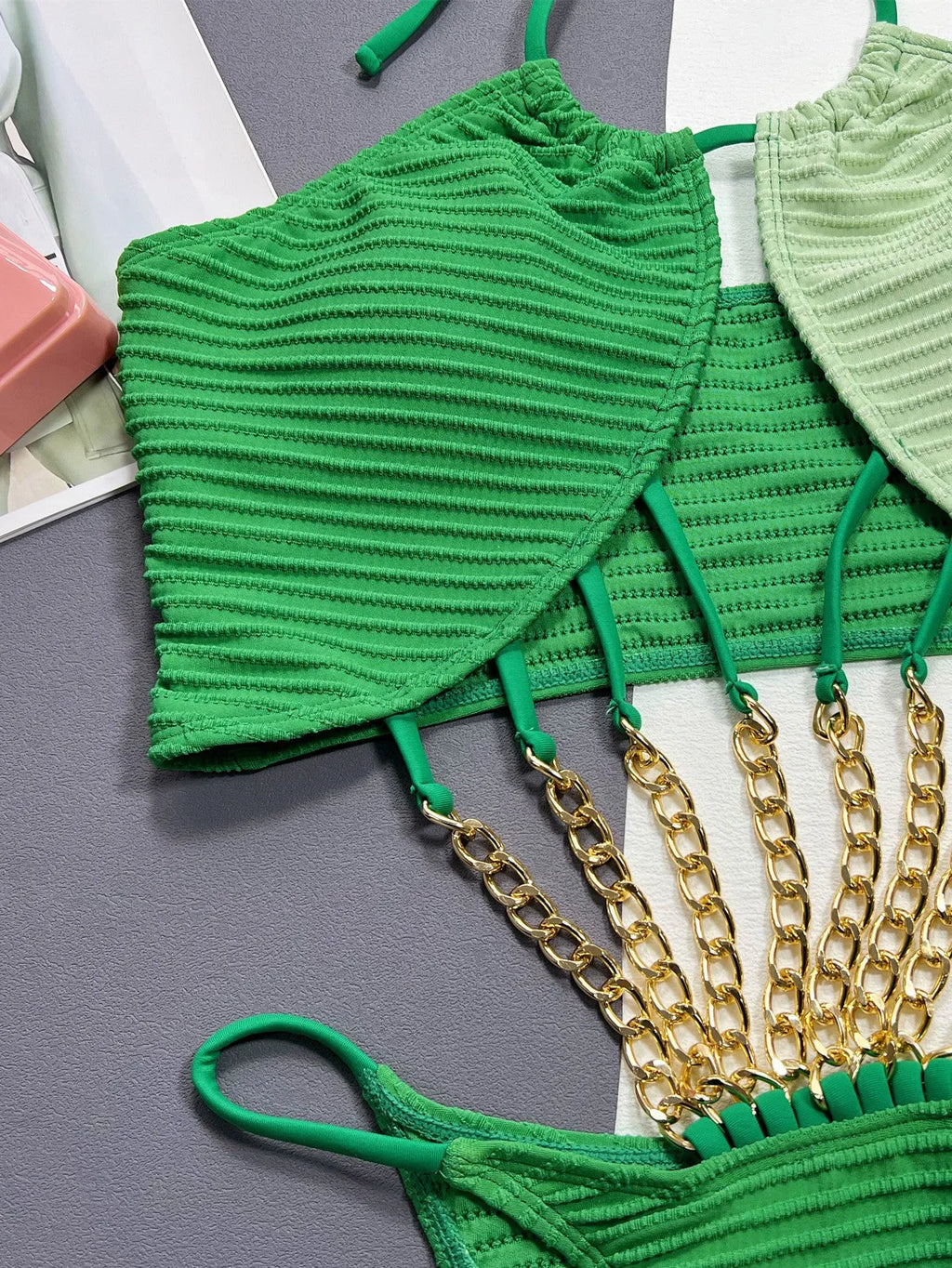 Green women's one-piece swimsuit with hollow cut-out design showing front view