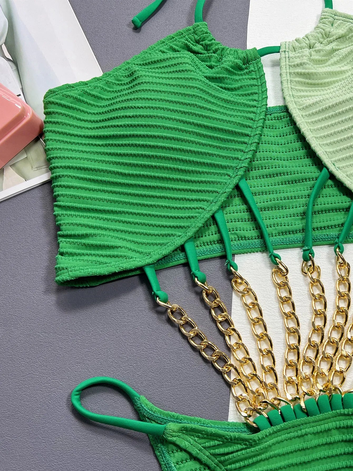 Green women's one-piece swimsuit with hollow cut-out design showing front view
