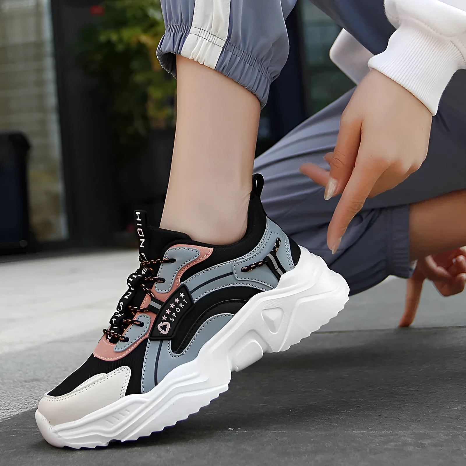 Women's white thick-soled casual sports shoes with mesh upper, round toe, and buckle closure.