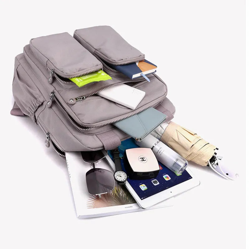 Women's waterproof nylon travel backpack with multiple internal compartments in various colours