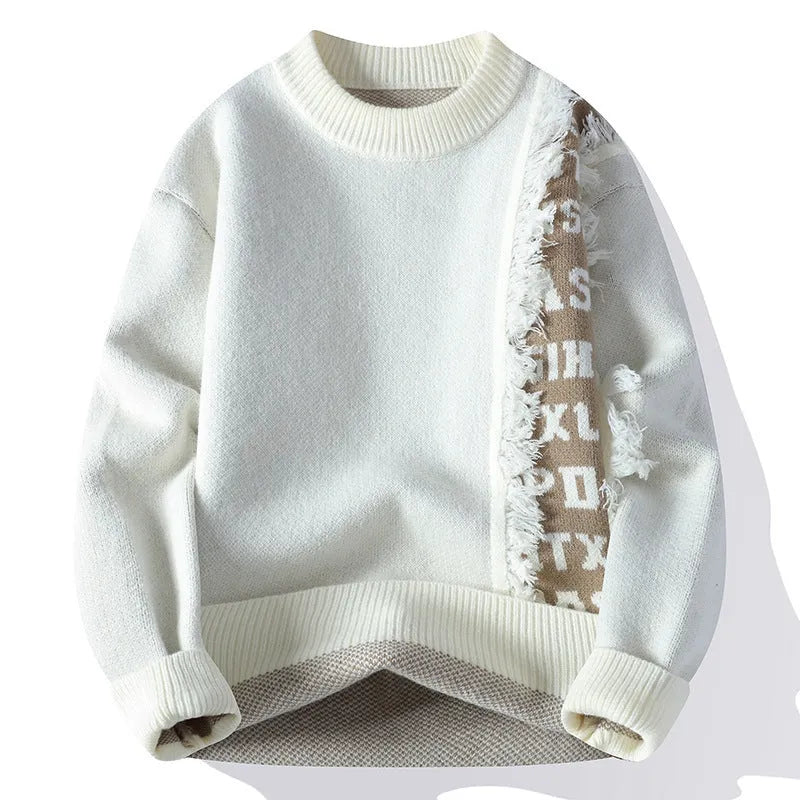 Man wearing a grey loose fit knitted pullover with long sleeves and a ribbed hemline.