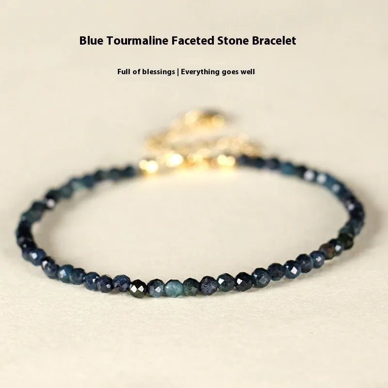 Close-up of a women's blue tourmaline beaded bracelet with 3mm gemstone beads and spacer details.