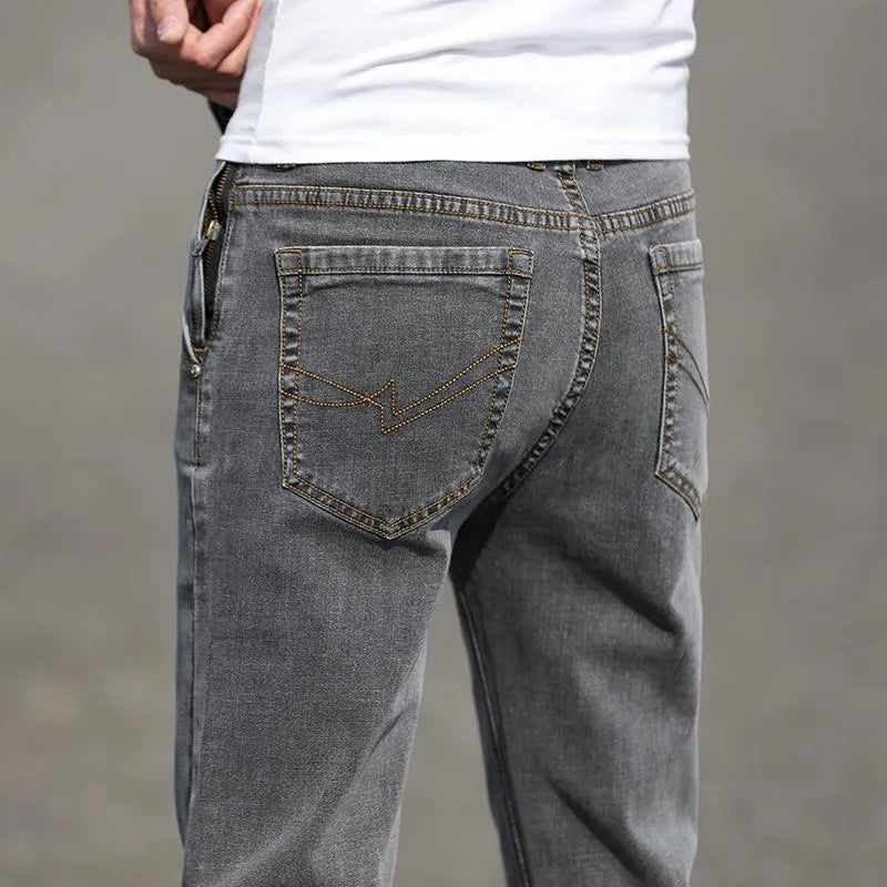 Men's smoky gray straight tube jeans with low waist and zipper fly closure