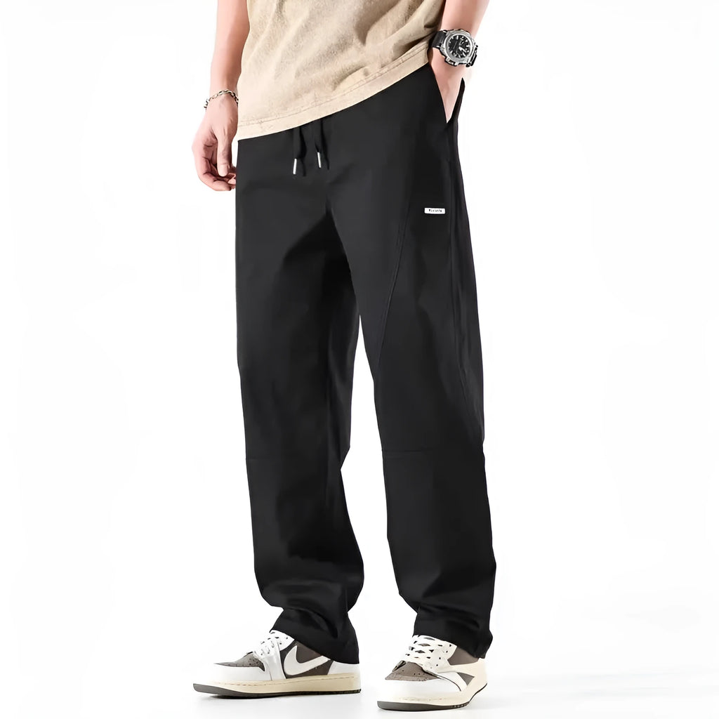 Cotton wide-leg casual trousers in Milky White hanging on a hanger, showing relaxed fit and full length.