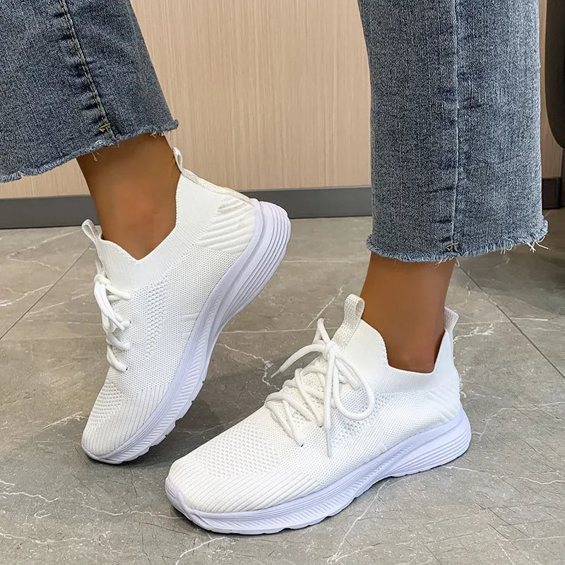 Women's Flyknit running shoes in Creamy White with mesh lining and rubber sole