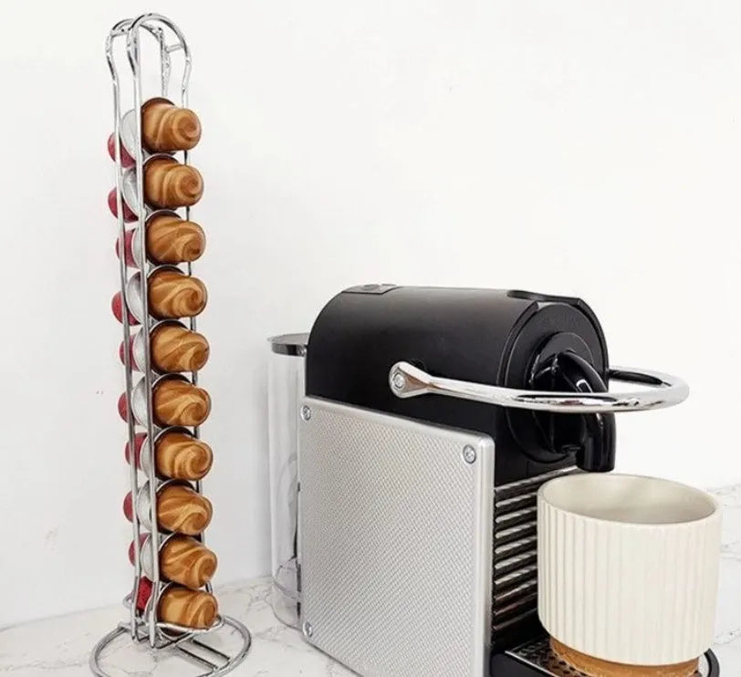 Black wrought iron coffee capsule storage rack holding pods on open shelves