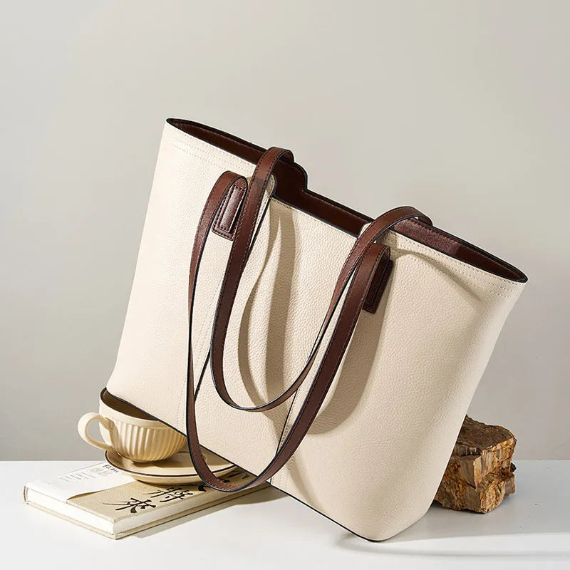 Women's black genuine leather crossbody bag with internal organiser compartments showing document and phone sections