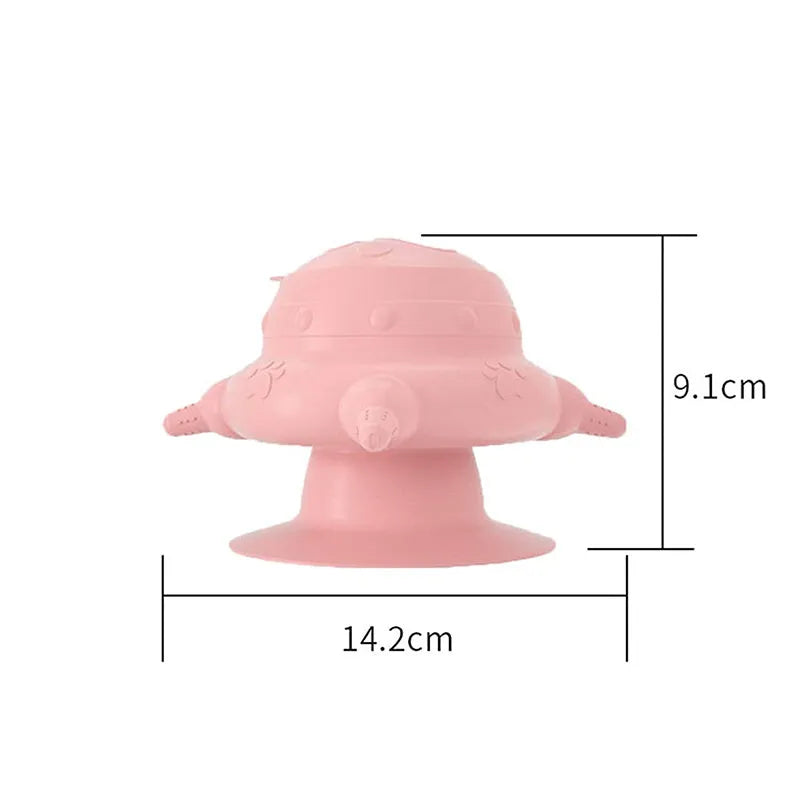 Pink silicone pet nursing feeder with bionic breast-shaped bowl and four pacifiers on a white background.