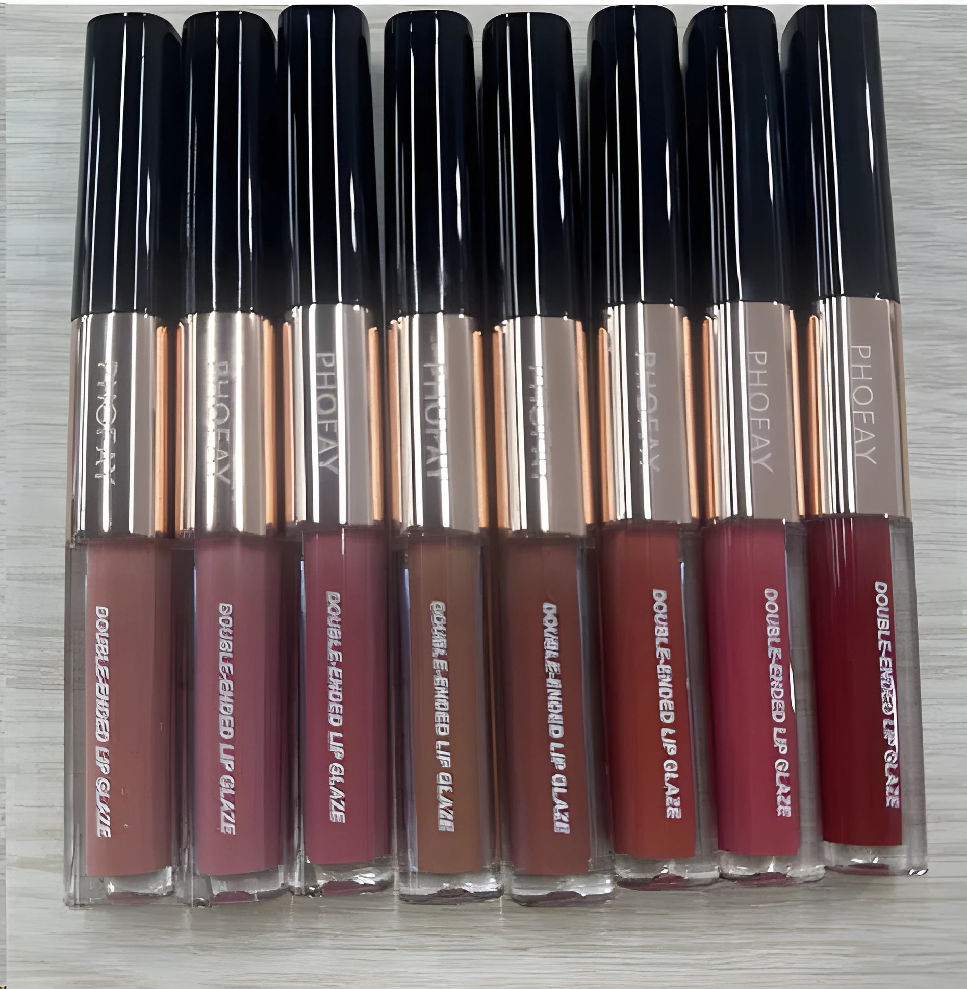 C-L021 double-head non-stick cup lip gloss showing two applicators and eight transparent colour shades.