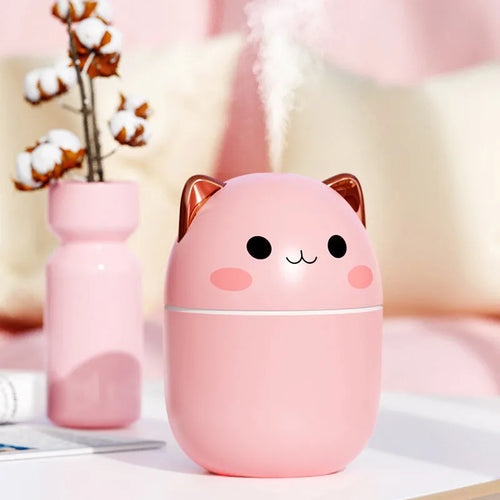 Cute cat-shaped USB air humidifier with LED cool mist spray in white, for office and bedroom use.