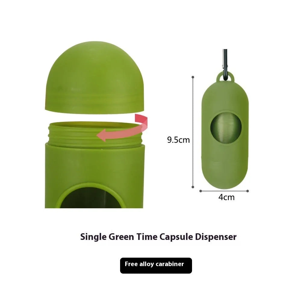 Roll of green EPI degradable dog poo bags next to a white plastic dispenser on a grass background.