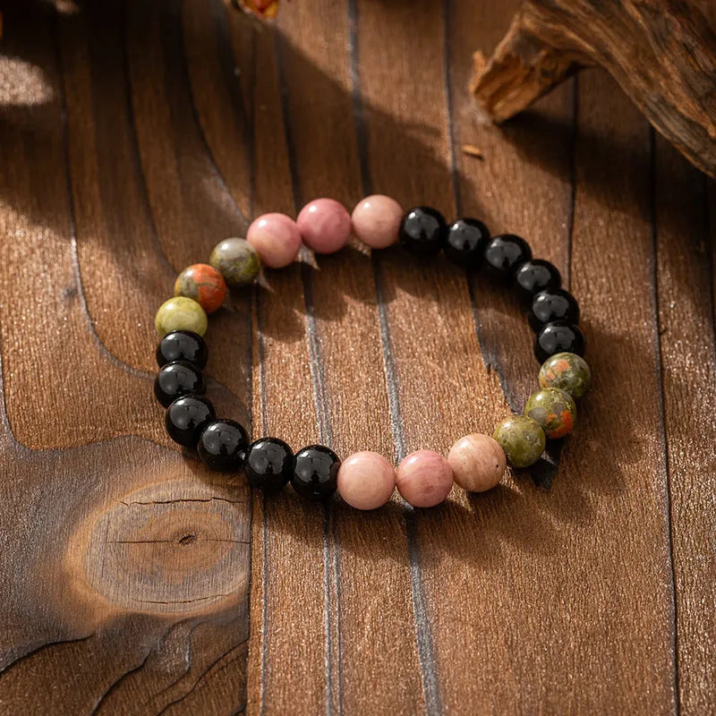 Vintage bohemian long necklace with geometric stone beads and tassel, shown with a matching shorter bracelet.