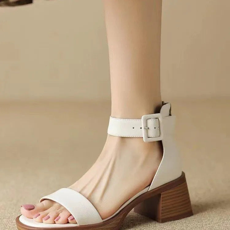 Women's white retro platform high heels with an ankle strap, shown from the side.