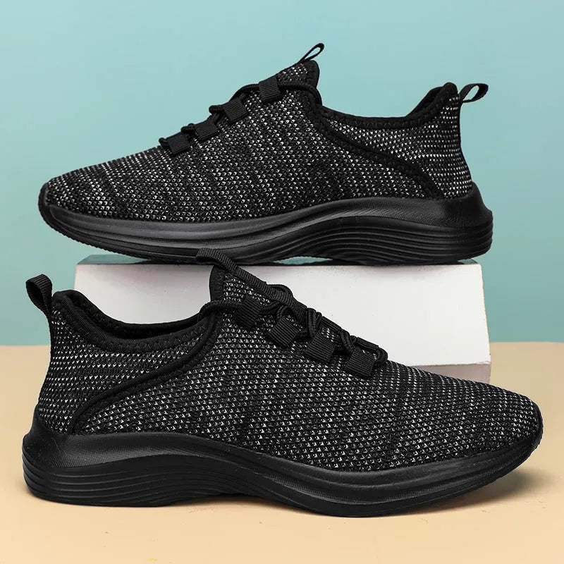 Women's low-top casual sneakers in black with flyknit mesh upper and lace-up front.