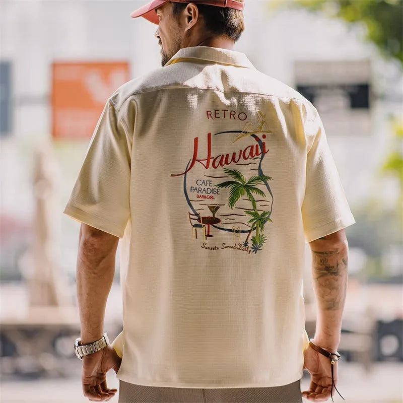 Light apricot men's short sleeve shirt with a bamboo floral pattern and a Cuban collar.