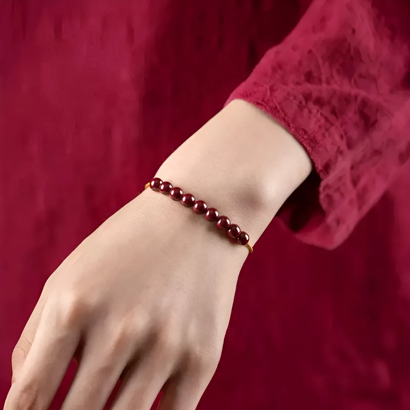 Hand-woven geometric bracelet made from raw Cinnabar and Hetian Jade ore on a wrist.