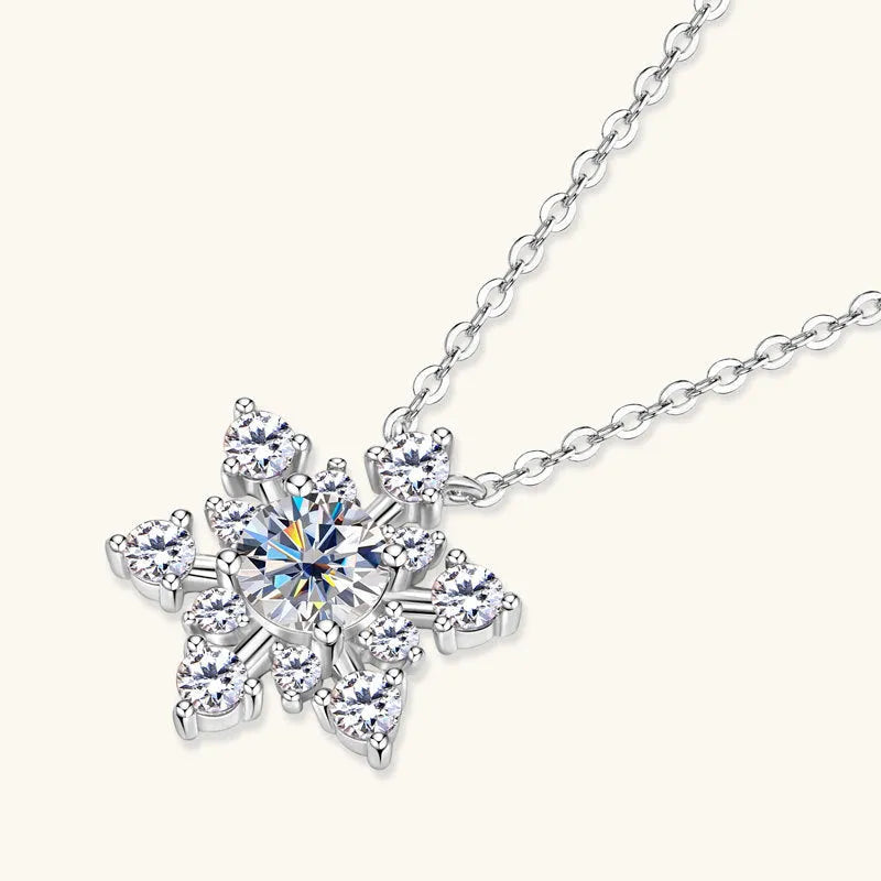 Gold snowflake moissanite pendant on silver 925 O-ring chain against white background